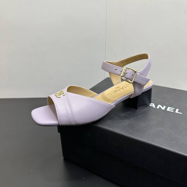 Chanel's new open-toe chunky-heeled sandals, featuring the classic double-C meta